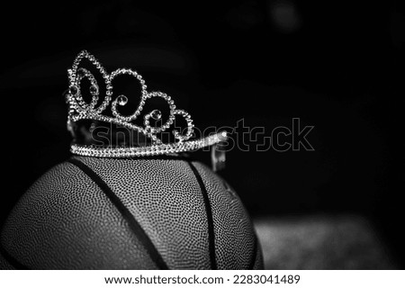 Basketball, tiara, and blank bracket signifying a Cinderella season.