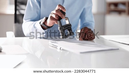 Approved Notary Stamp Rubber Stamp. Hand Pressing One Royalty-Free Stock Photo #2283044771