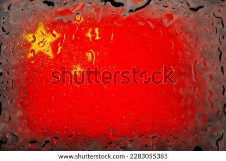China flag. China flag on the background of water drops. Flag with raindrops. Splashes on glass. Abstract background