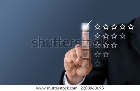 Close up Man hand give five star symbol to increase rating of product and service concept, Customer service and business satisfaction survey,selective focus.