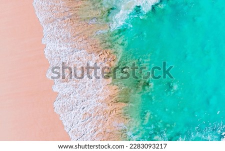 Aerial shot of waves crashing onto a beach