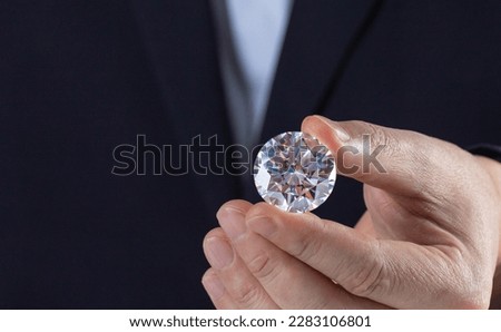 Close up of diamond in hand of expert in evaluating process gemstone. Royalty-Free Stock Photo #2283106801