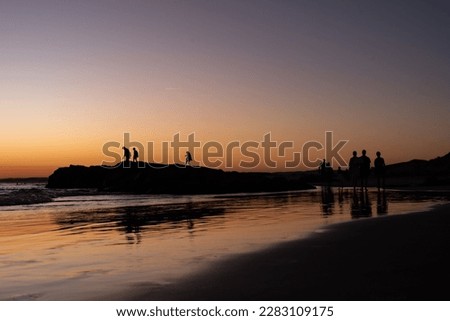 silhouettes at sunset at Birubi Beach