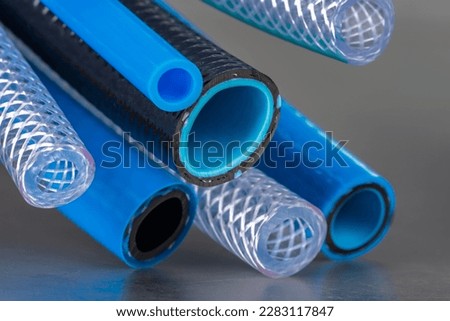 Bunch of flexible water and air hose pipe Royalty-Free Stock Photo #2283117847