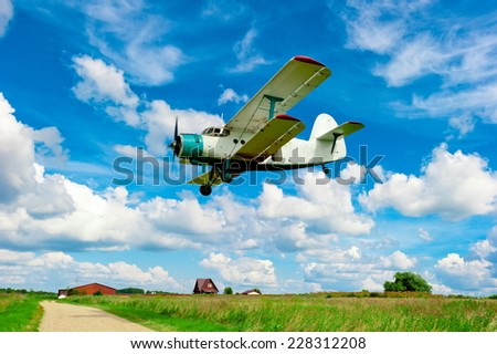 agricultural aircraft flying low over a field