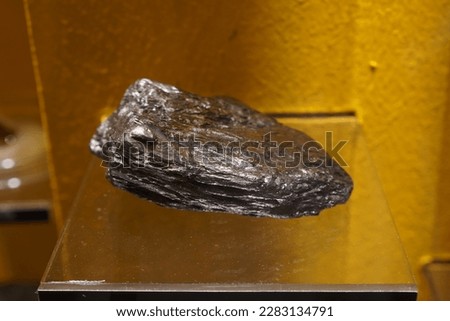Raw specimen of Graphite rock stone show in the Geological Museum. Mineral and Stone Museum. Royalty-Free Stock Photo #2283134791