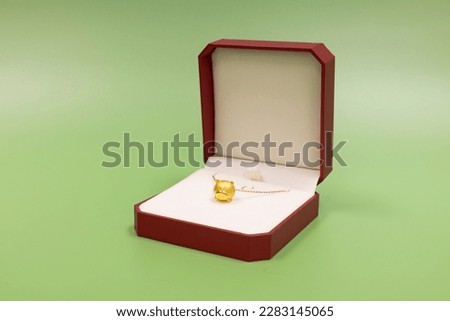 Jewelry and gift box purchased from a store specializes in selling jewelery and watches in Hong Kong, China. green background