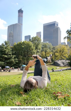 Young woman in Central Park using smartphone