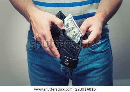 Man gets $ 100 from her purse Royalty-Free Stock Photo #228314815