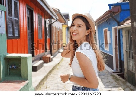 Portrait of stylish cheerful tourist woman turns around and smile at camera visiting Paranapiacaba village, Sao Paulo, Brazil Royalty-Free Stock Photo #2283162723