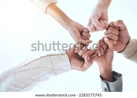 Below business people, fist bump and circle for team building, support and group goals in workplace. Men, women and teamwork with solidarity for success, motivation and trust with diversity at job Royalty-Free Stock Photo #2283175745