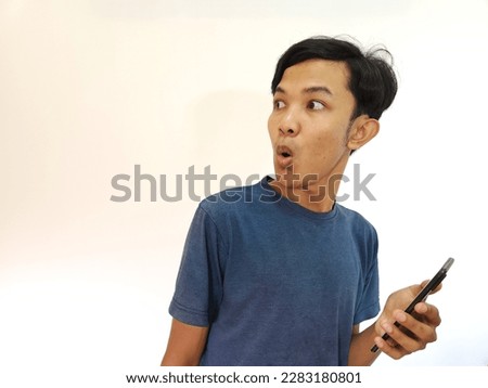 Shocked and surprised face of man with a phone in isolated on white background