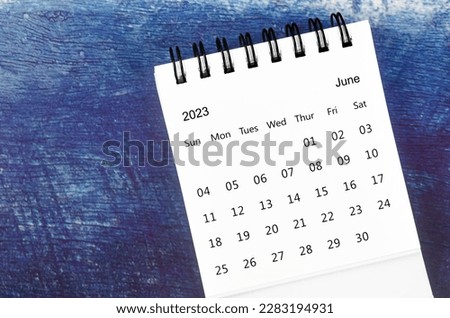 June Monthly desk calendar for 2023 year on old blue wooden background. Royalty-Free Stock Photo #2283194931