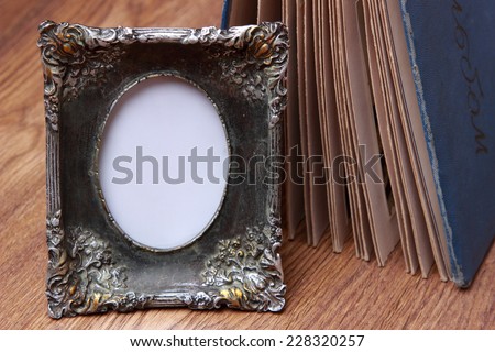 Blank photo frame on wooden background
