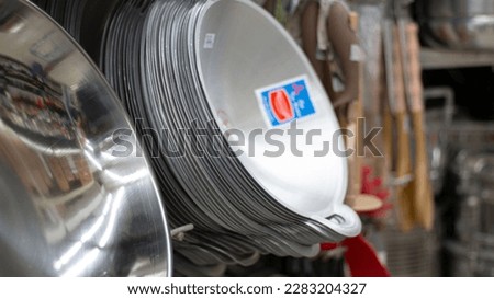 Homemade of traditional alumunium pan hanging on stick in the market for sale Royalty-Free Stock Photo #2283204327