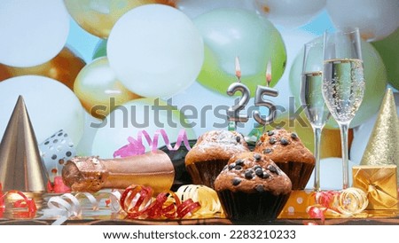 Happy birthday champagne background with number of candles  25. Beautiful congratulations copy space for anniversary.
Festive decorations with a bottle of champagne in pastel colors.