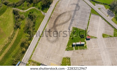 Aerial view of a 8 drawn with tires on the asphalt.