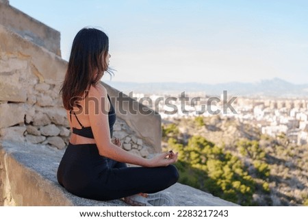 Cheerful young girl does yoga poses outdoors