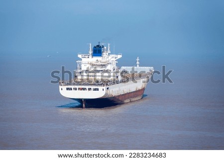 Anchored, white painted ship anchored at sea calm sea. 
