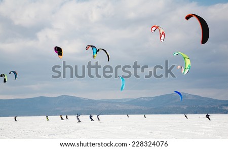 Sportsmen snowkiting at sport winter competition Royalty-Free Stock Photo #228324076