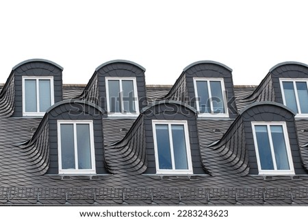 Attic windows on the roof of an old building, isolated against white background