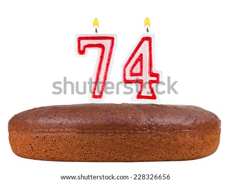 birthday cake with candles number 74 isolated on white background