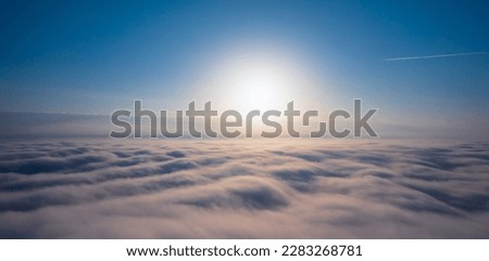 Be inspired by the beauty and majesty of a dawn sky with this awe-inspiring image of a sunrise over clouds. The breathtaking colors and serene atmosphere will fill you with hope and joy