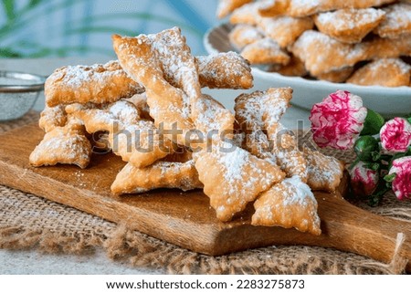 Traditional Italian carnival fritters dusted with icing sugar - frappe or chiacchiere Royalty-Free Stock Photo #2283275873