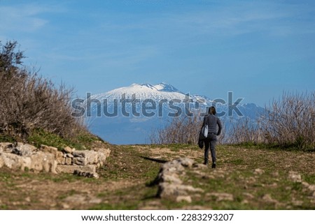 A tourist watch the Etna volcano from Morgantina, Sicily