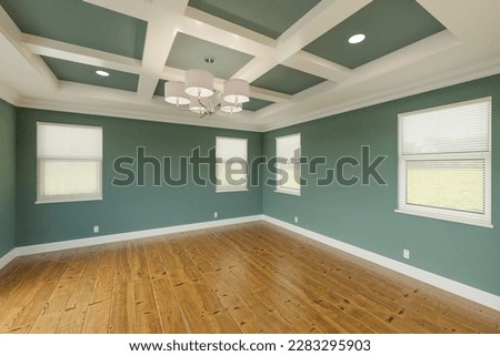 Beautiful Muted Teal Custom Master Bedroom Complete with Fresh Paint, Crown and Base Molding, Hard Wood Floors and Coffered Ceiling Royalty-Free Stock Photo #2283295903