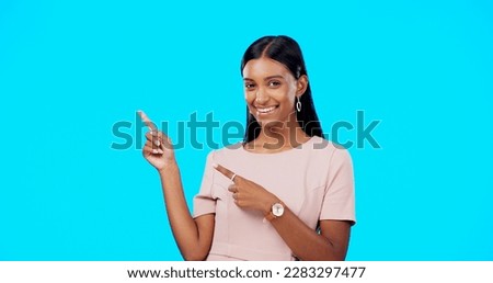 Mock up, happy studio or woman point at sales promotion, present gift or discount deal mockup. Female portrait, advertising space or marketing product placement for person isolated on blue background