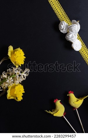 Easter decoration and flowers flat lay, yellow on black, holiday spring decor, chickens