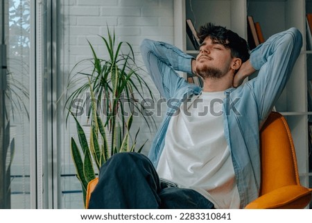 young man at home relaxing on the sofa Royalty-Free Stock Photo #2283310841