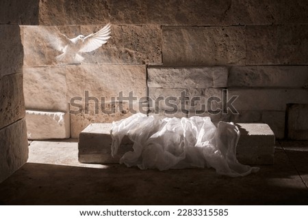 Jesus Christ crucifixion death and resurrection and easter dove flying in a stone tomb Royalty-Free Stock Photo #2283315585