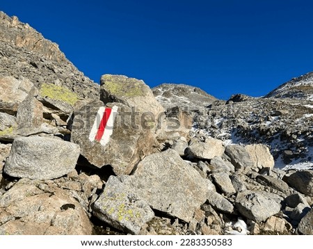 Alpine mountaineering signposts and markings in the mountainous area of the Albula Alps and above the Swiss mountain road pass Fluela (Flüelapass), Zernez - Canton of Grisons, Switzerland (Schweiz)