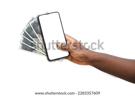 Black hand holding mobile phone with blank screen and Egyptian pound notes Royalty-Free Stock Photo #2283357609