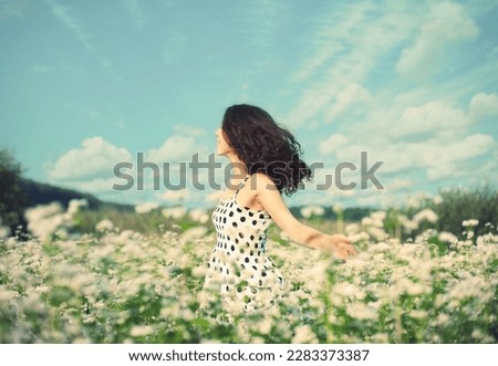 Young happy girl walking on the flowering buckwheat field. #uniquesself Royalty-Free Stock Photo #2283373387