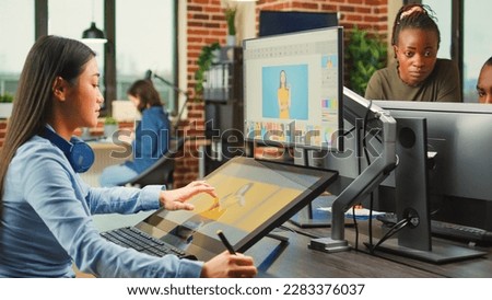 Artistic graphic designer working with touchscreen monitor to edit images, using tablet and stylus pen. Photographer editing photos to create professional content, retouching software.