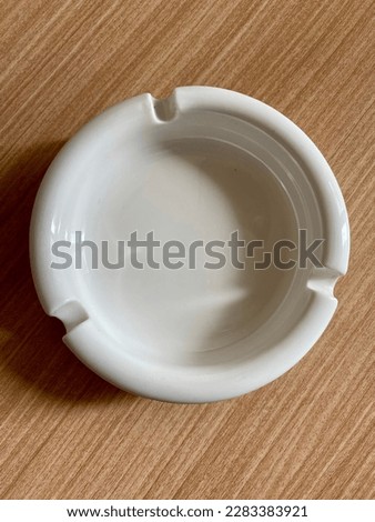 Cigarette ashtray on a wooden background on a table