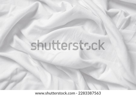Closeup of rippled white silk fabric,white fabric draped in soft waves empty bed sheet Royalty-Free Stock Photo #2283387563