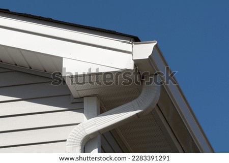 colonial white gutter guard system, fascia, drip edge, soffit providing ventilation to the attic roof line Royalty-Free Stock Photo #2283391291