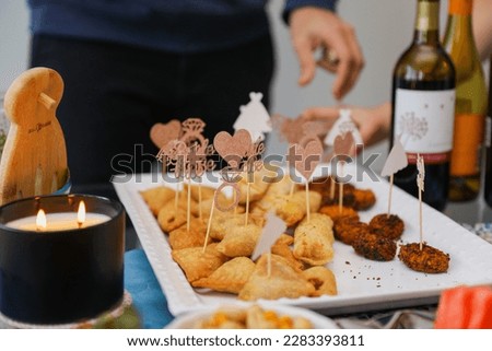 elegantly arranged charcuterie board displaying various meats, cheeses, fruits, and nuts. It symbolizes the joy of abundance and shared experiences, emphasizing the importance of enjoying life