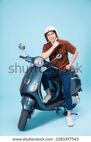 Image of yougn Asian man on motorbike Royalty-Free Stock Photo #2283397543