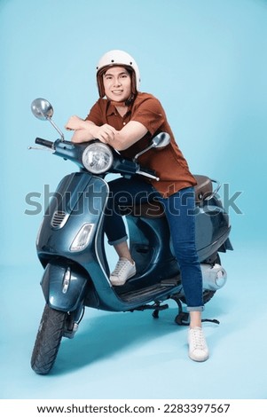 Image of young Asian man on motorbike Royalty-Free Stock Photo #2283397567