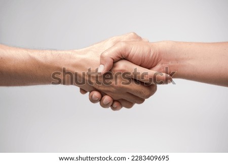Close up two man shaking hand on white background.Athletes shaking hands before sports competition. Unity and teamwork concept. Royalty-Free Stock Photo #2283409695