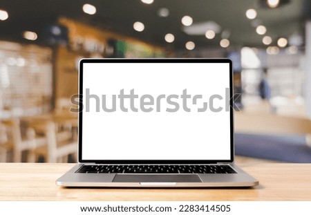 Laptop blank screen on wood table with coffee cafe background, mockup, template for your text, Clipping paths included for background and device screen Royalty-Free Stock Photo #2283414505