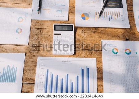 Financial analysts analyze business financial reports on a digital tablet planning investment project during a discussion at a meeting of corporate showing the results of their successful teamwork.