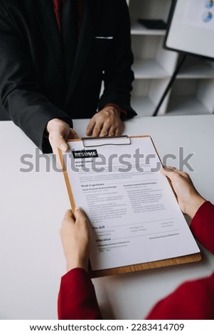 Close up view of job interview in office, focus on resume writing tips, employer reviewing good cv of prepared skilled applicant, recruiter considering application, hr manager making hiring decision Royalty-Free Stock Photo #2283414709