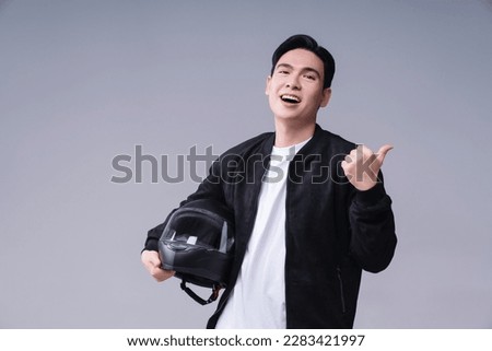 Image of young Asian man with helmet on background Royalty-Free Stock Photo #2283421997