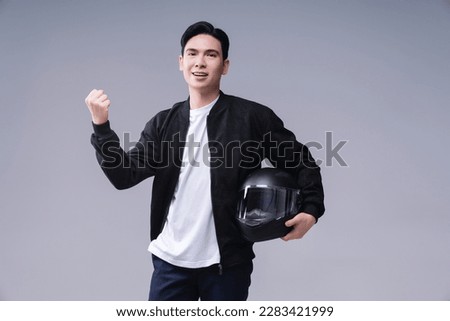 Image of young Asian man with helmet on background Royalty-Free Stock Photo #2283421999